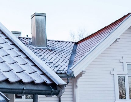 Pipe på toppen av taket i kaldt vær