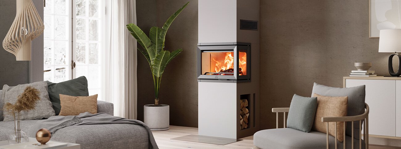 Jøtul I 520 FRL peisinnsats i hvit fareg foran grå vegg